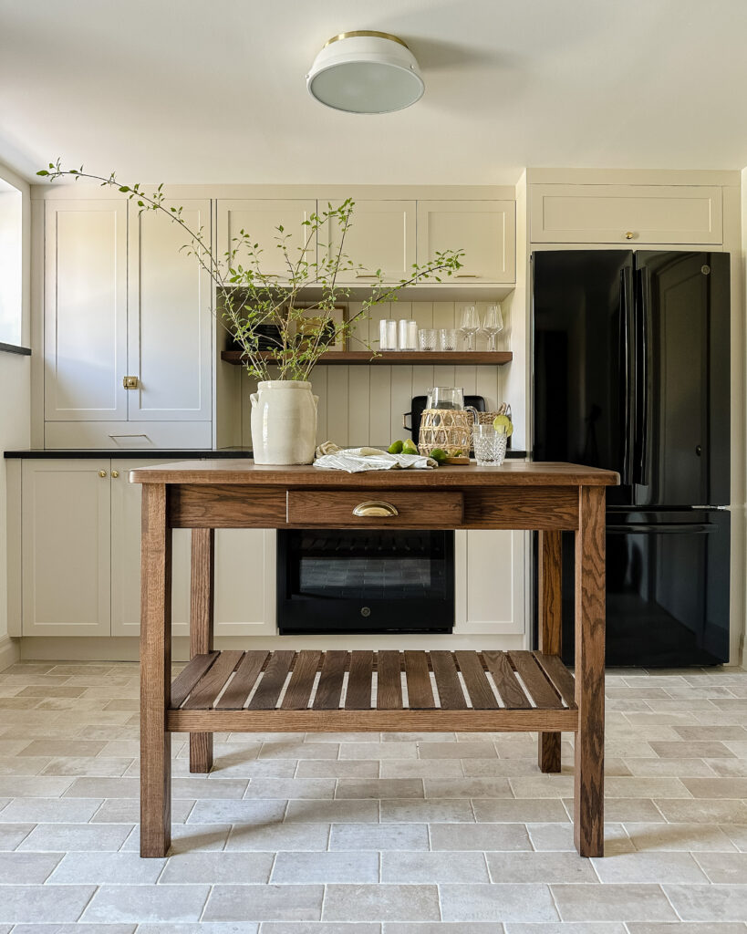 kitchenette with limestone look tiles and wood island