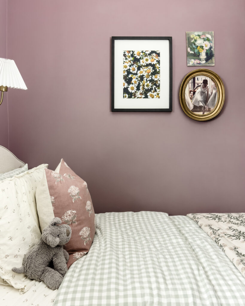 Girls bedroom with purple walls, green gingham bedding, and a gallery wall with florals and ballerinas.